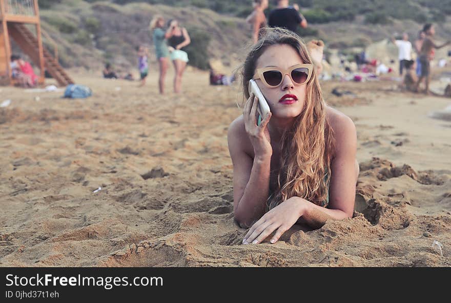 Photography of a Woman Lying on Sand