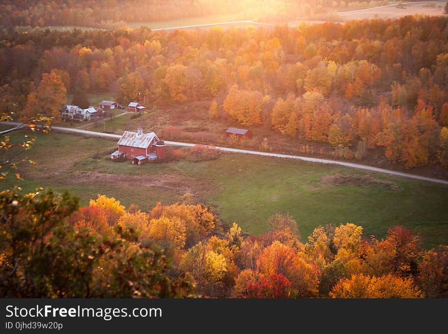 Aerial View of Red and White Painted Barn Near Green Grass Yard