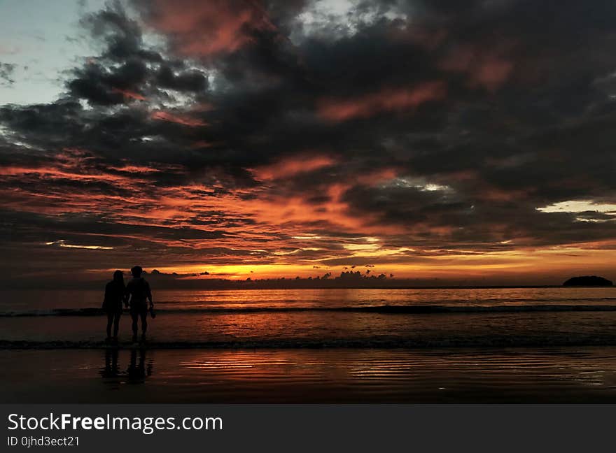 Two Person Standing on Beach Silhouette Photo