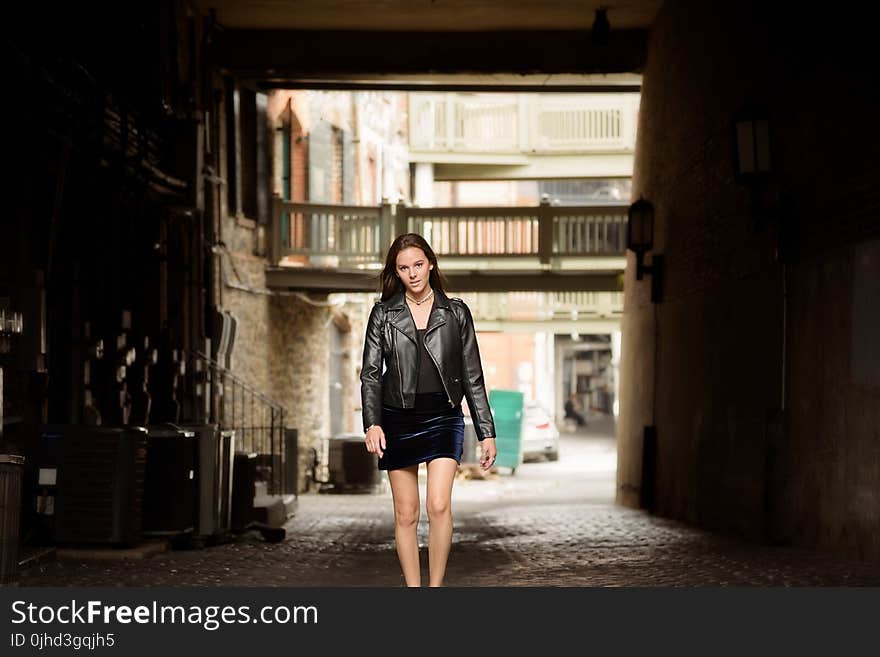 Woman in Black Leather Jacket and Skirt