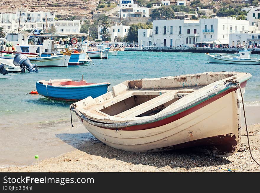 White and Maroon Jon Boat on Seashore