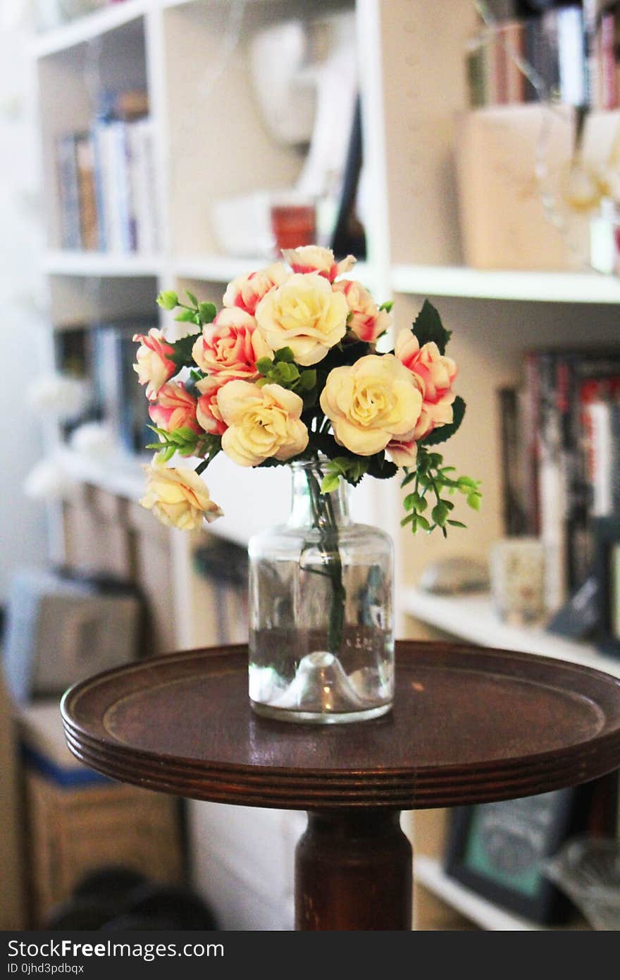 Arrange of Petal Flower in Clear Glass Vase at Table