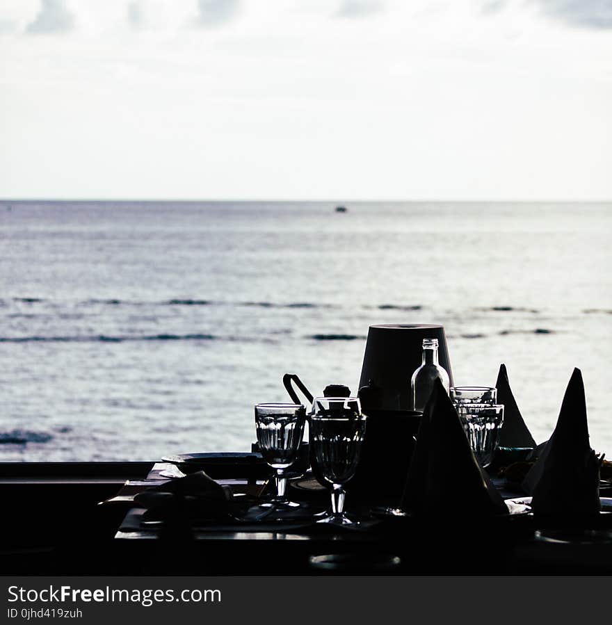 Grayscale Photography of Four Sherbet Glasses on Table