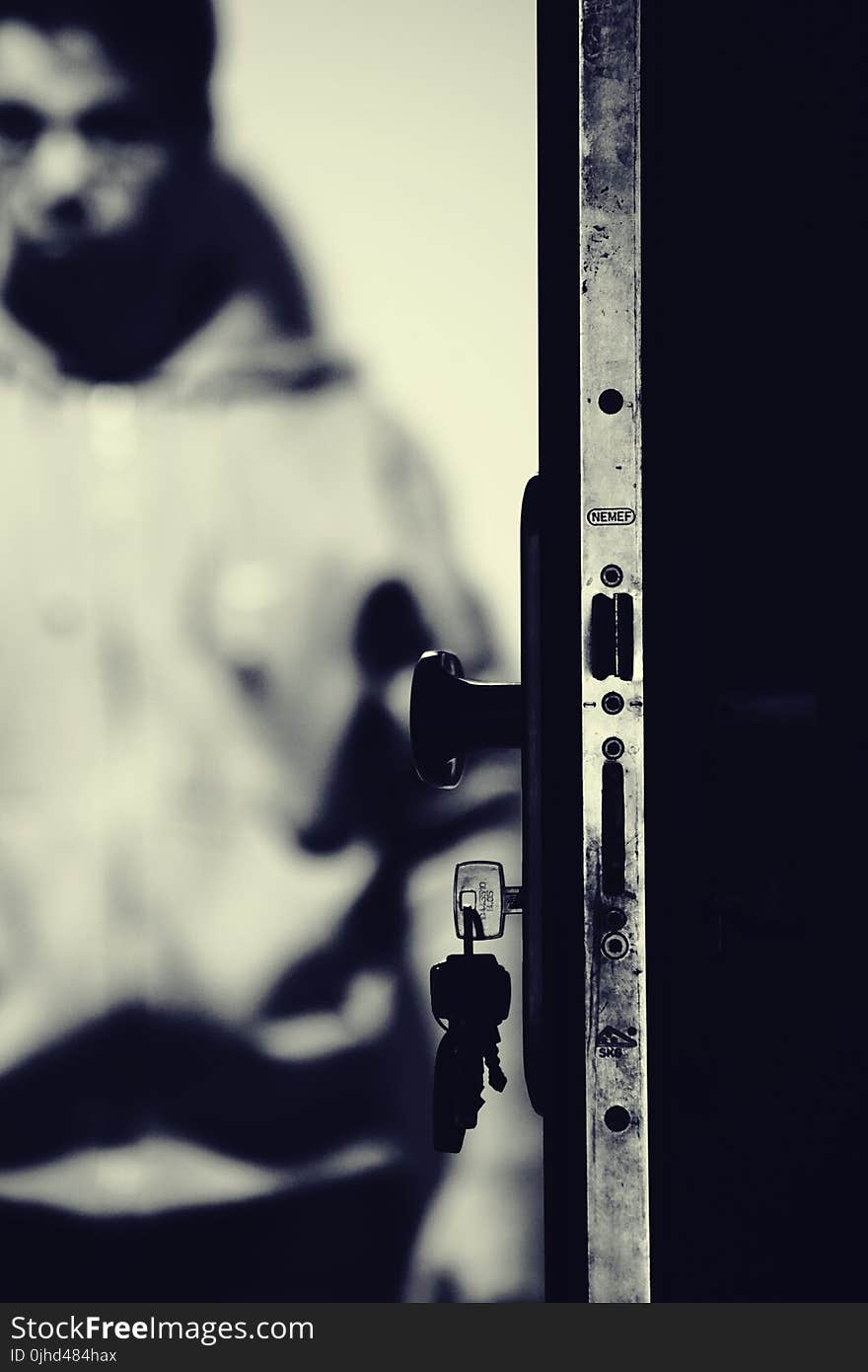 Monochrome Photo of Keys and Door Knob