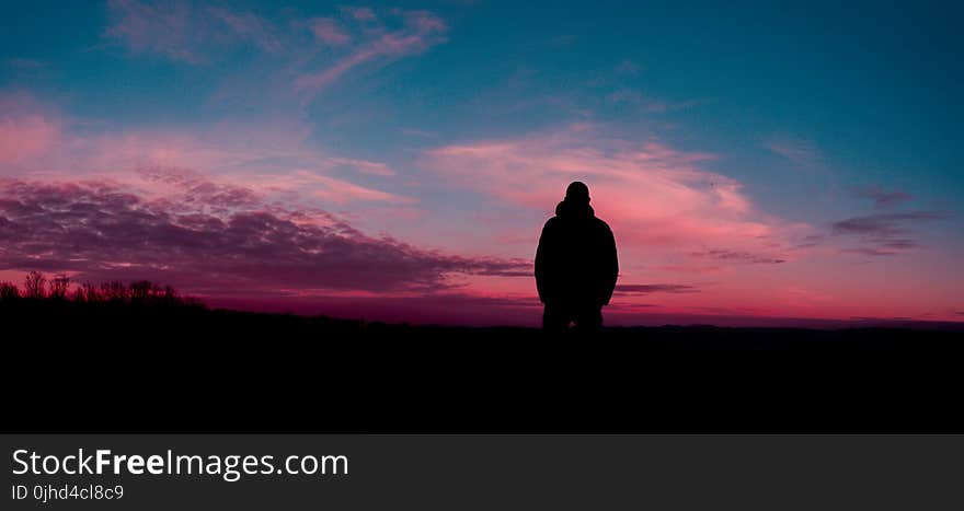 Silhouette of Human With Sunset Background