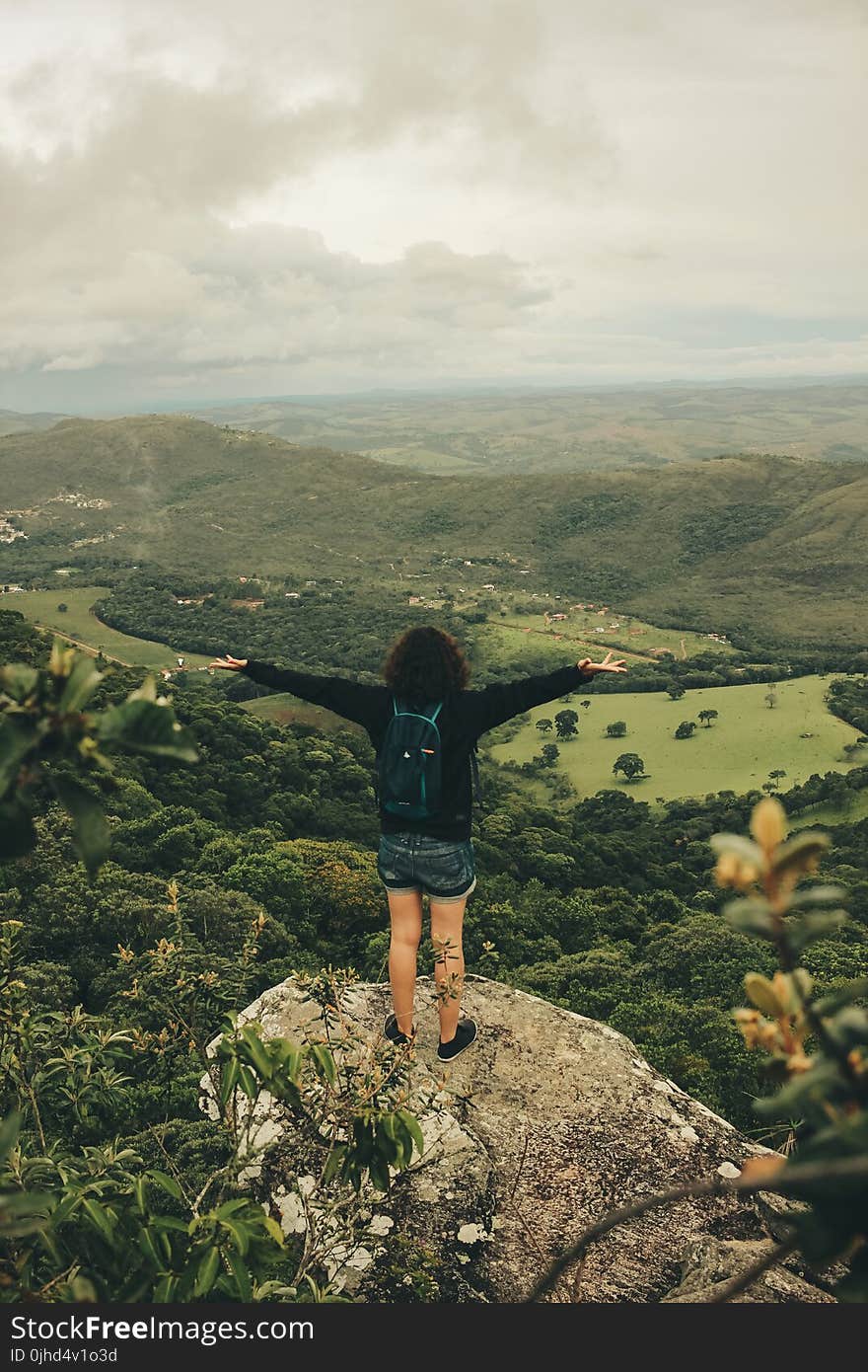 Woman in Black Long-sleeved Top With Blue Denim Shorts