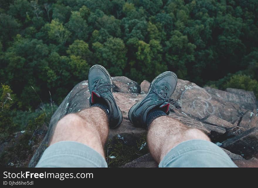 Man Standing on Edge of Mountain