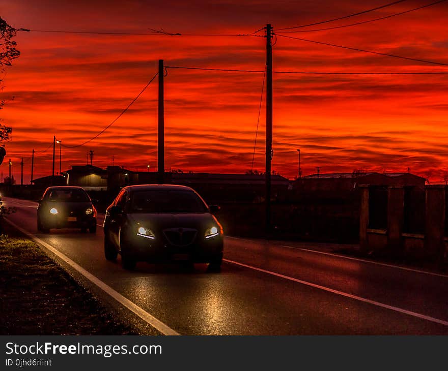 Two Cars On Road During Golden Hour