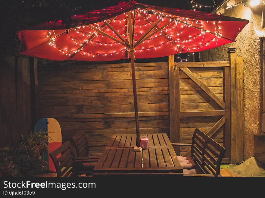 Photography of Red Patio Table With String Lights