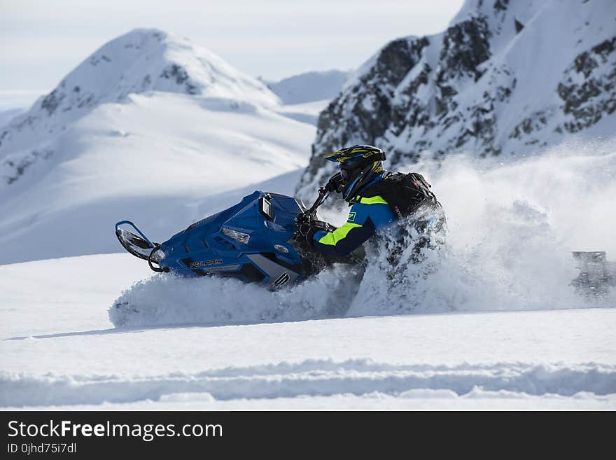 Person Riding on Snowmobile