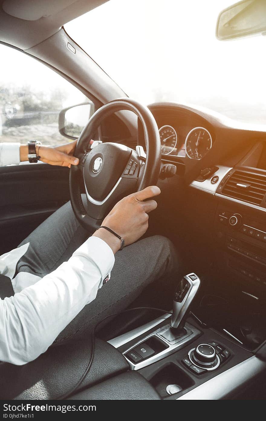 Man in White Dress Shirt Holding Steering Wheel