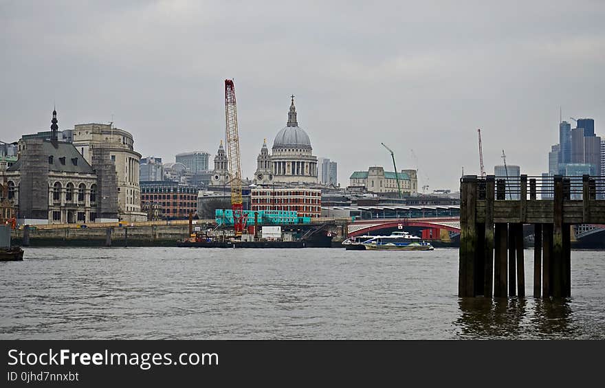 Photography Of Body Of Water Beside City Buildings