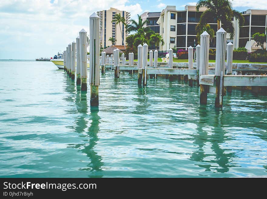 Photo of White Wooden Dock on Body of Water