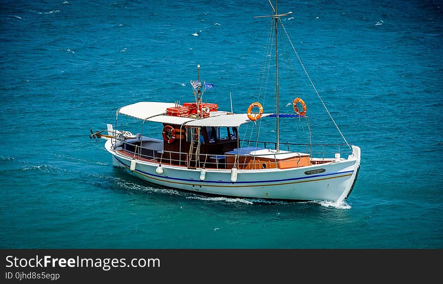 White Sail Boat On Sea