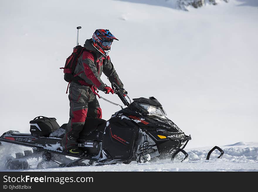 Person Riding on Snowmobile