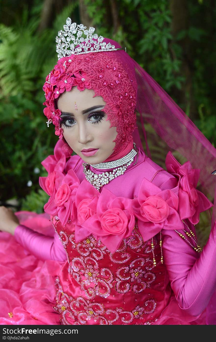 Woman Wears Pink Long-sleeved Dress With Crown