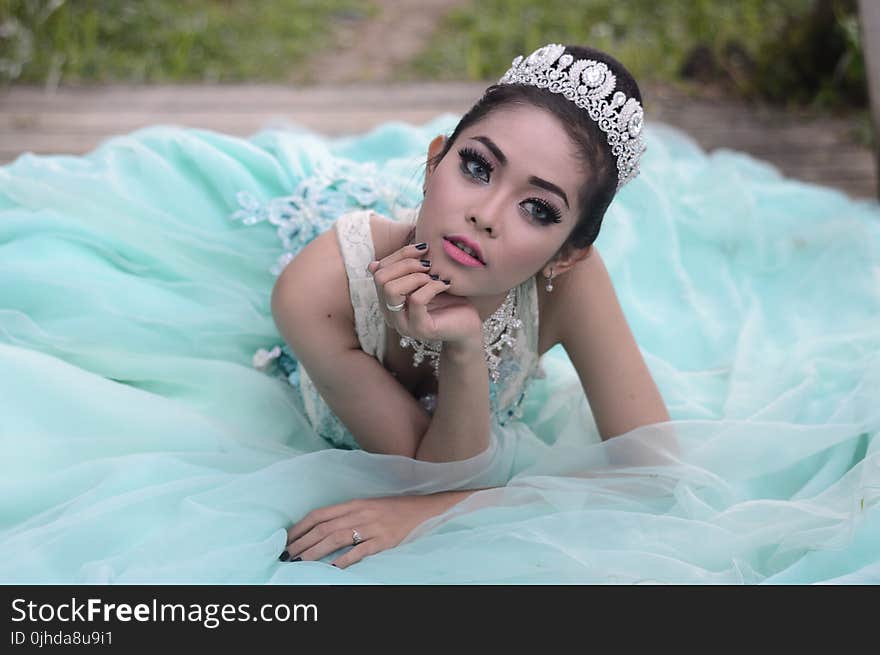 Woman Wearing Teal Dress in Reclining Position