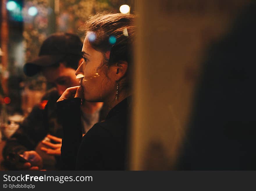 Close-up Photography of Woman in Black Long-sleeved Top