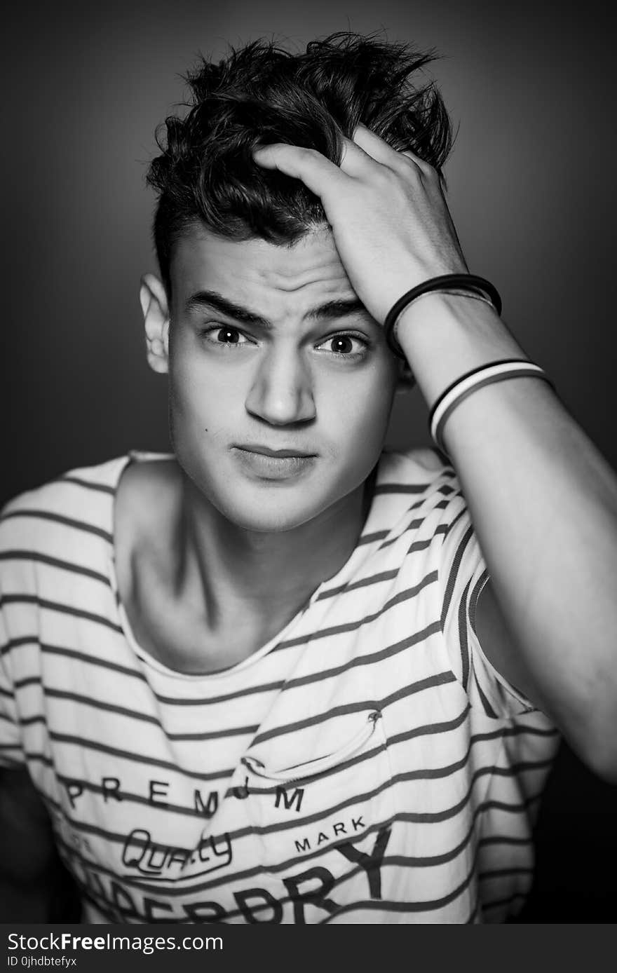 Man Wearing White and Black Striped T-shirt