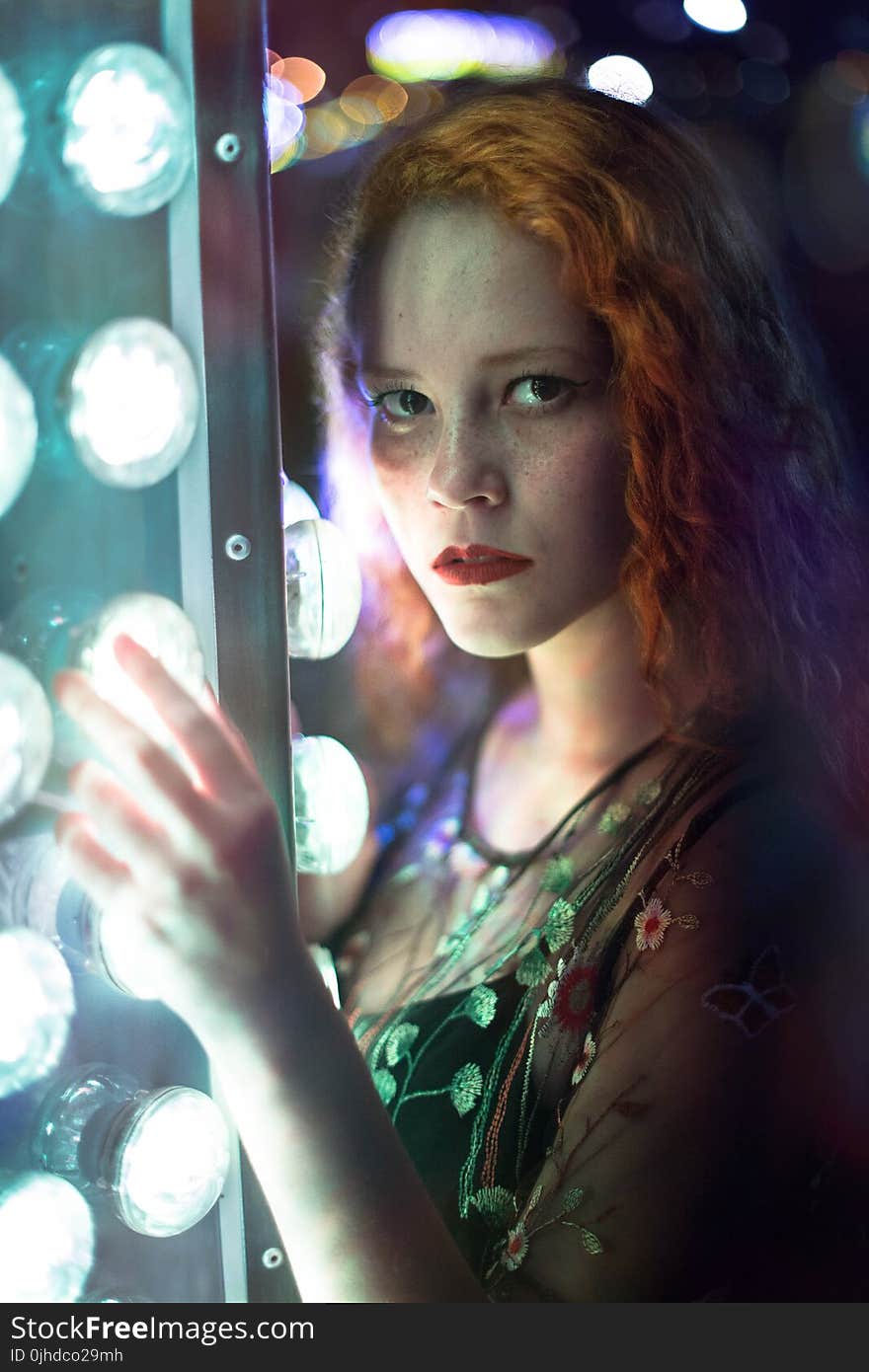 Woman in Green Dress Holding Gray Steel Frame