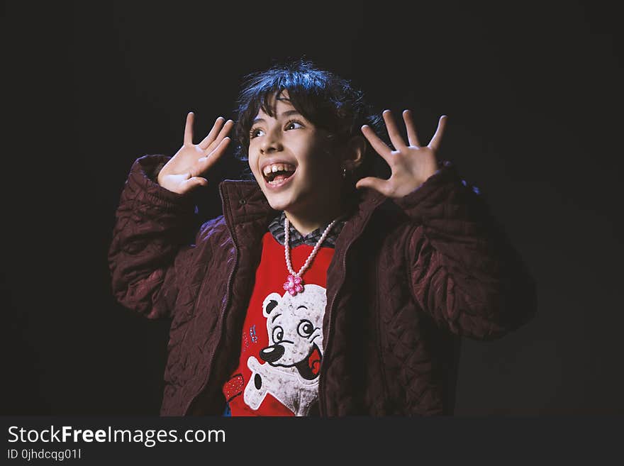 Boy Wearing Brown Zip-up Jacket in Room