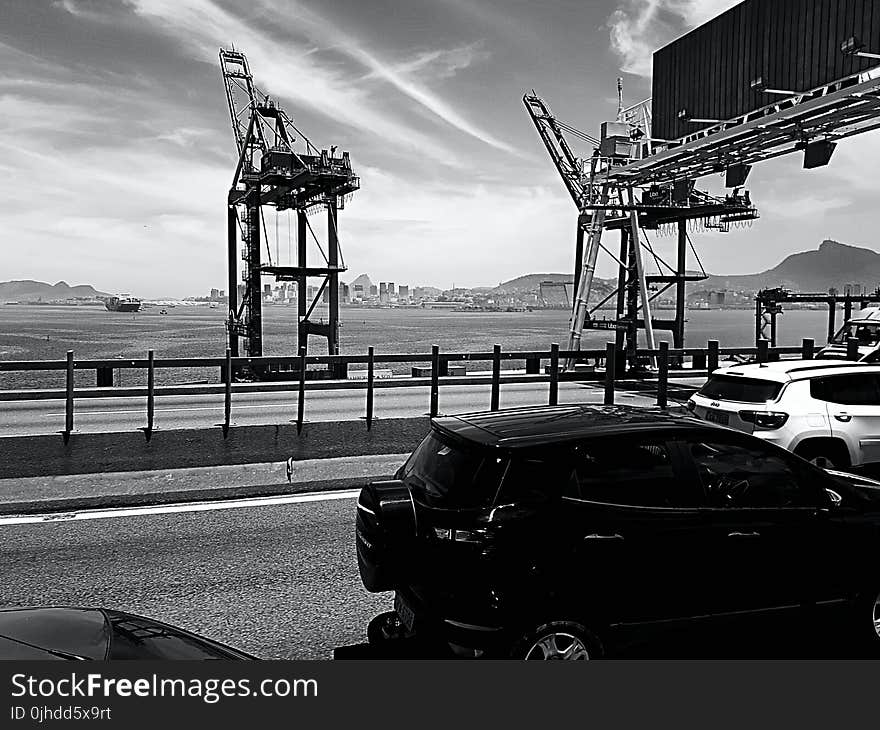 Gray Scale Photo of Black 5-door Hatchback Beside Black Sand Fields