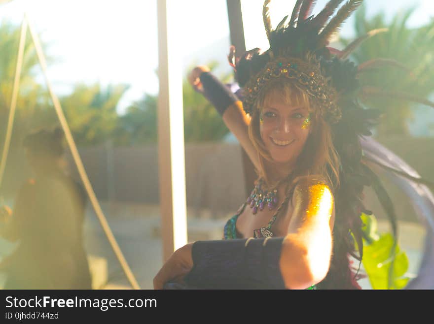 Woman Wearing Blue Spaghetti-strap Top With Feather Headdress