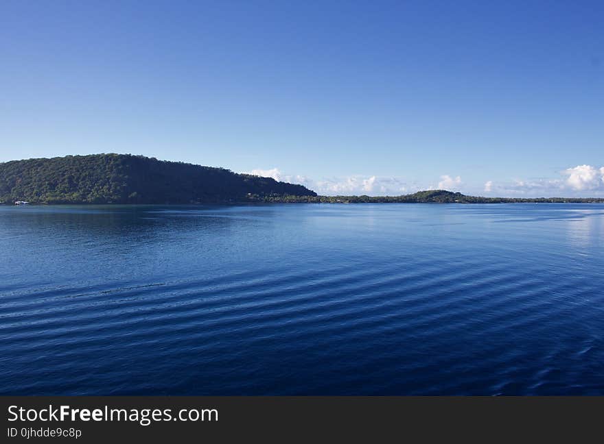 Landscape Photography of Body of Water Near Mountain