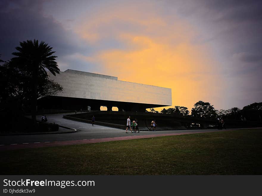 People Walking Near White Concrete Structure