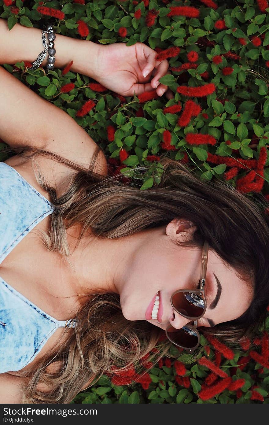 Woman in Blue Chambray Spaghetti Strap Dress Wearing Sunglasses With Red Flower Background