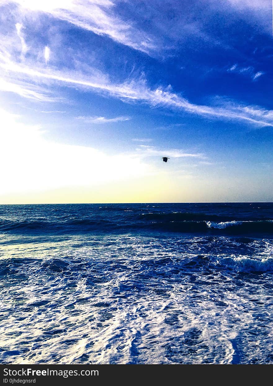 Photography of Water Waves Under Cloudy Sky