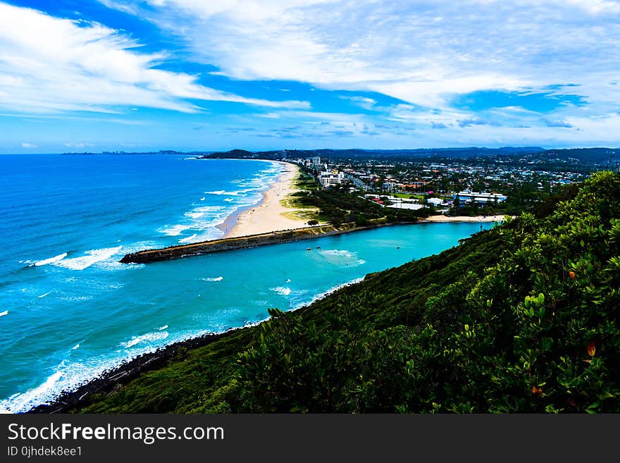 Blue Ocean Near Trees and Mountains Photo