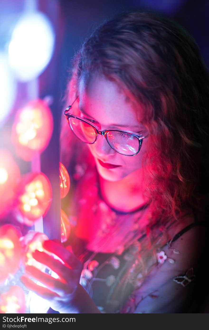 Woman in Black Sleeveless Top Wearing Black Framed Eyeglasses