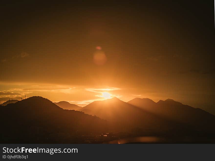 Silhouette Photo of Mountain Range during Golden Hour