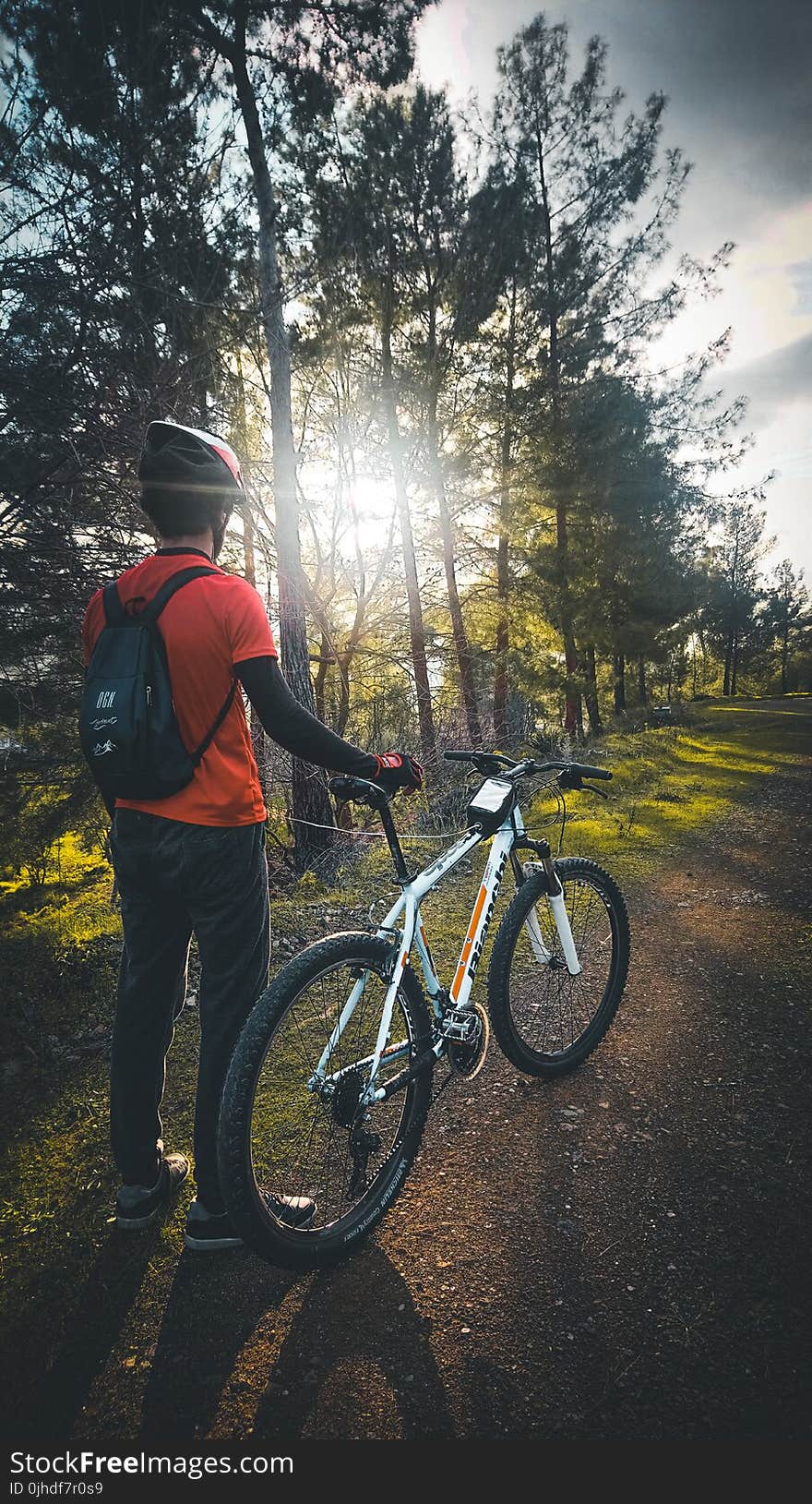 Photo of Man Wearing Red Shirt Holding White Mountain Bike