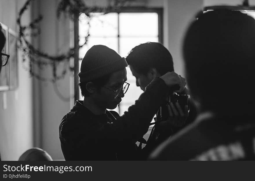 Grayscale Photo of Man Holding Man&#x27;s Neck