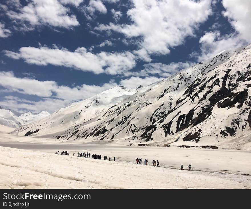 Snow-covered Mountain Under Cloudy Sky