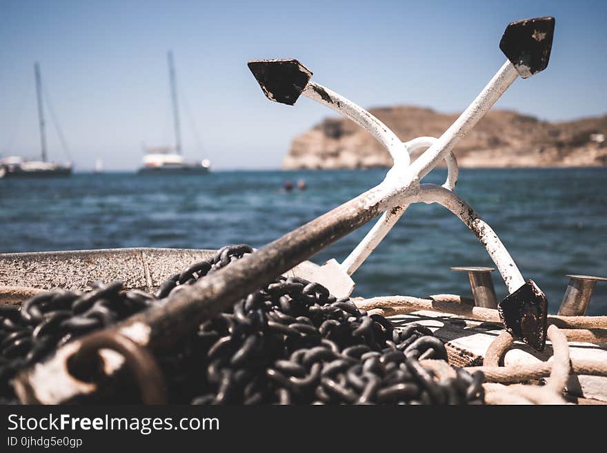 White and Black Anchor With Chain at Daytime