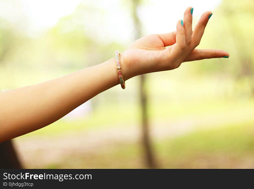 Close-Up Photography of Girl&#x27;s Left Hand Wearing Bracelet