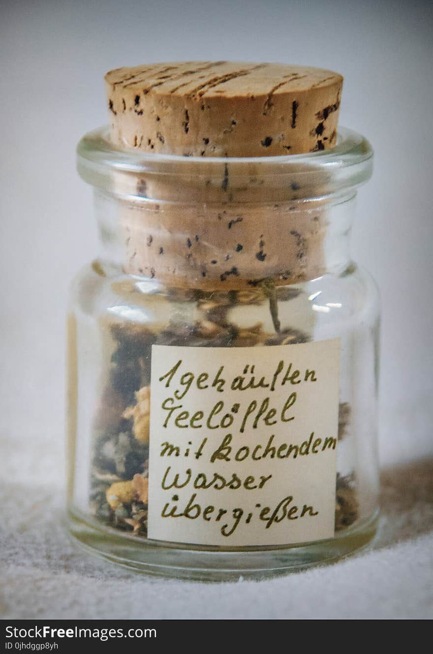 Paper Inside Clear Glass Jar With Brown Cork