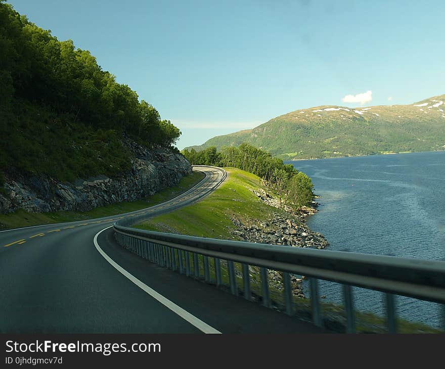 Concrete Road Near Body Of Water