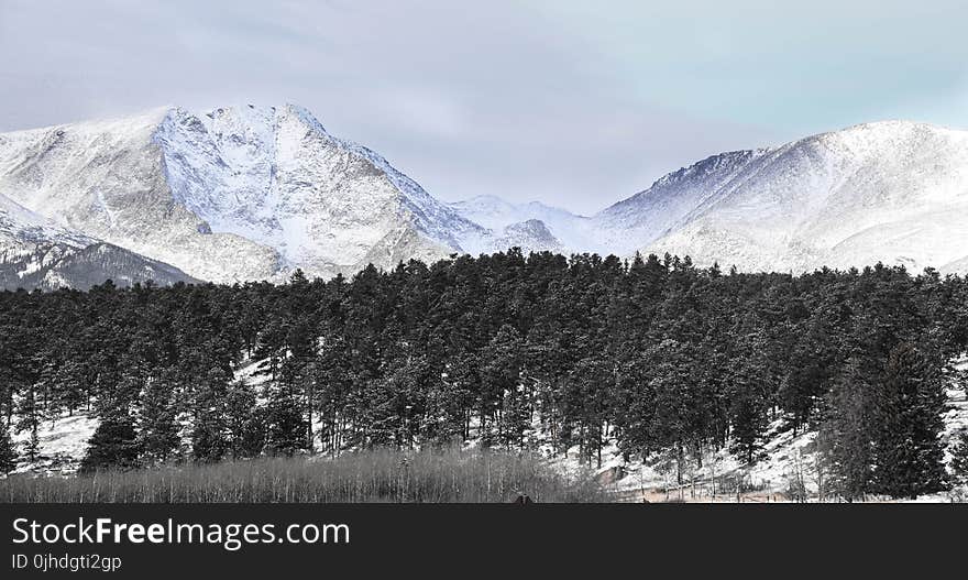 Snow Covered Mountains Under Cloudy Sky