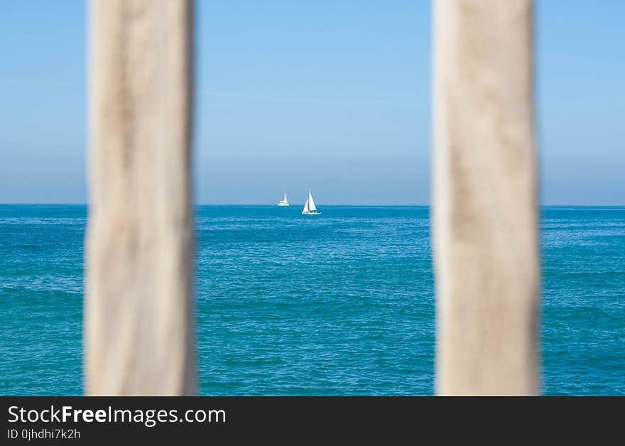 White Sailing Boat on Body of Water