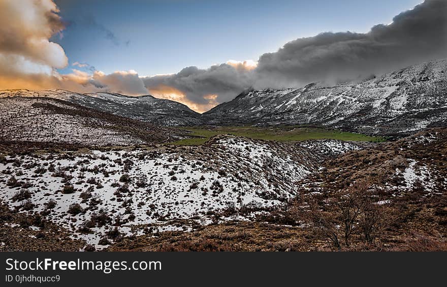 Scenic Photography of Mountains Covered With Snow Under Cloudy Sky