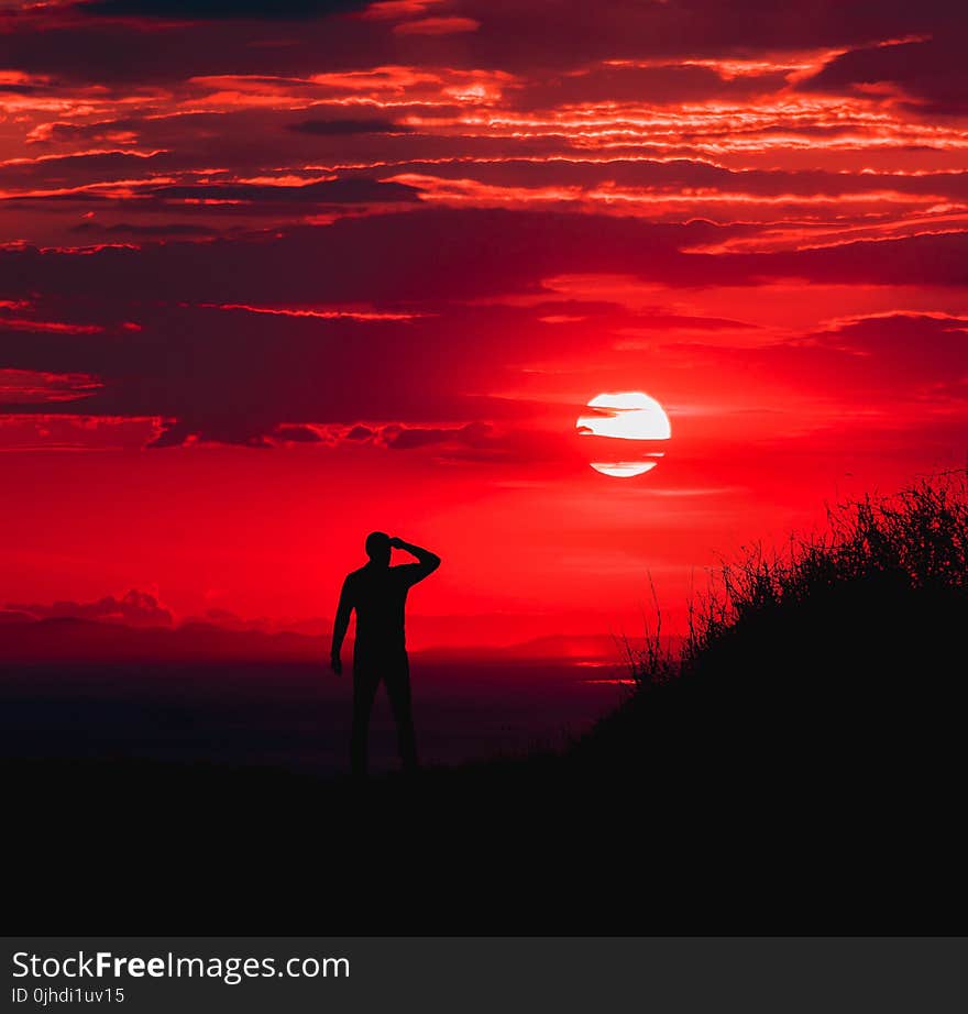 Silhouette of Man during Red Sun