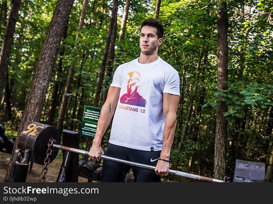 Photo of Man Holding Barbell