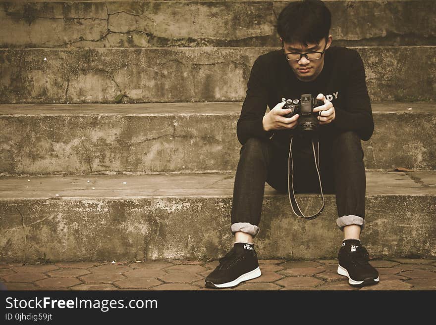 Photography of a Woman Holding DSLR Camera