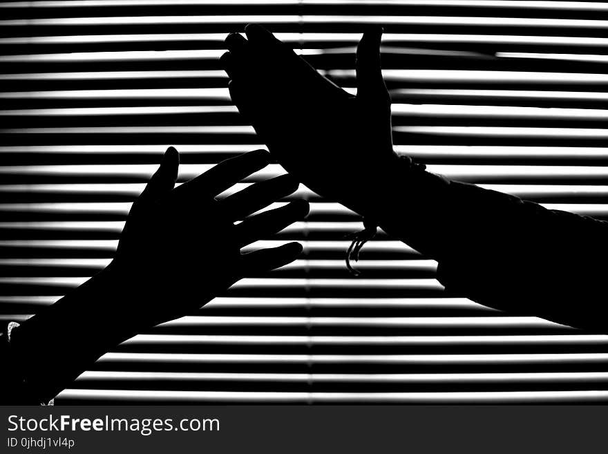 Silhouette of Hands With Venetian Blinds Background