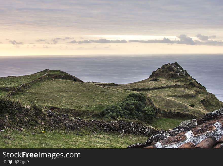 Green Grass Field Near an Ocean