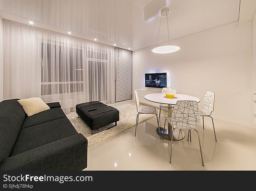 Black Fabric Sofa Near Round White Table